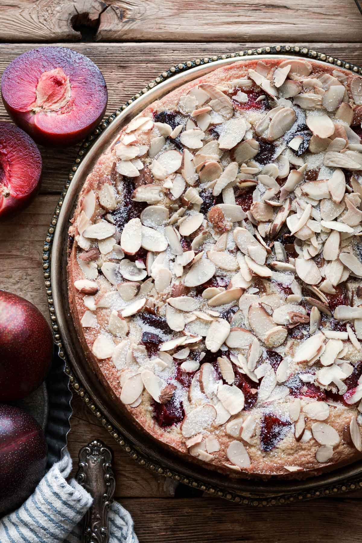 Almond plum cake with sliced almonds on top.
