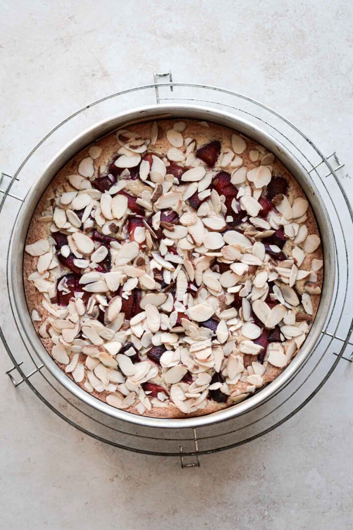 Step 4 for making almond plum cake - baked cake in pan.