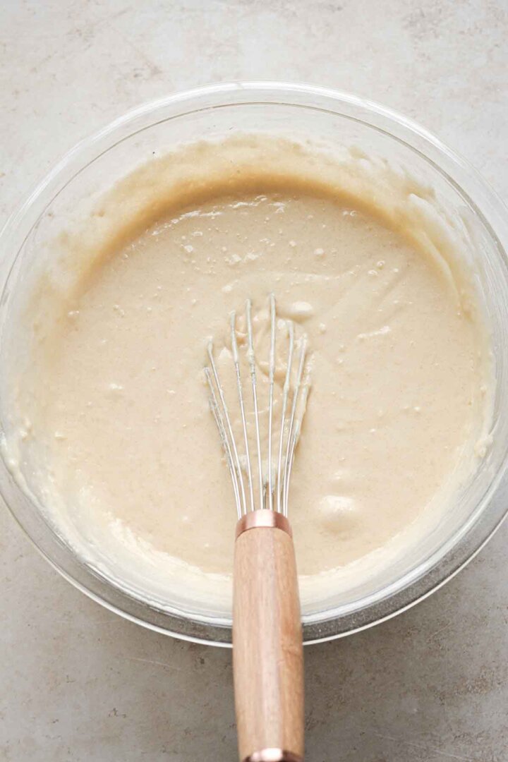 Step 3 for making vanilla cupcake batter - whisking the batter.