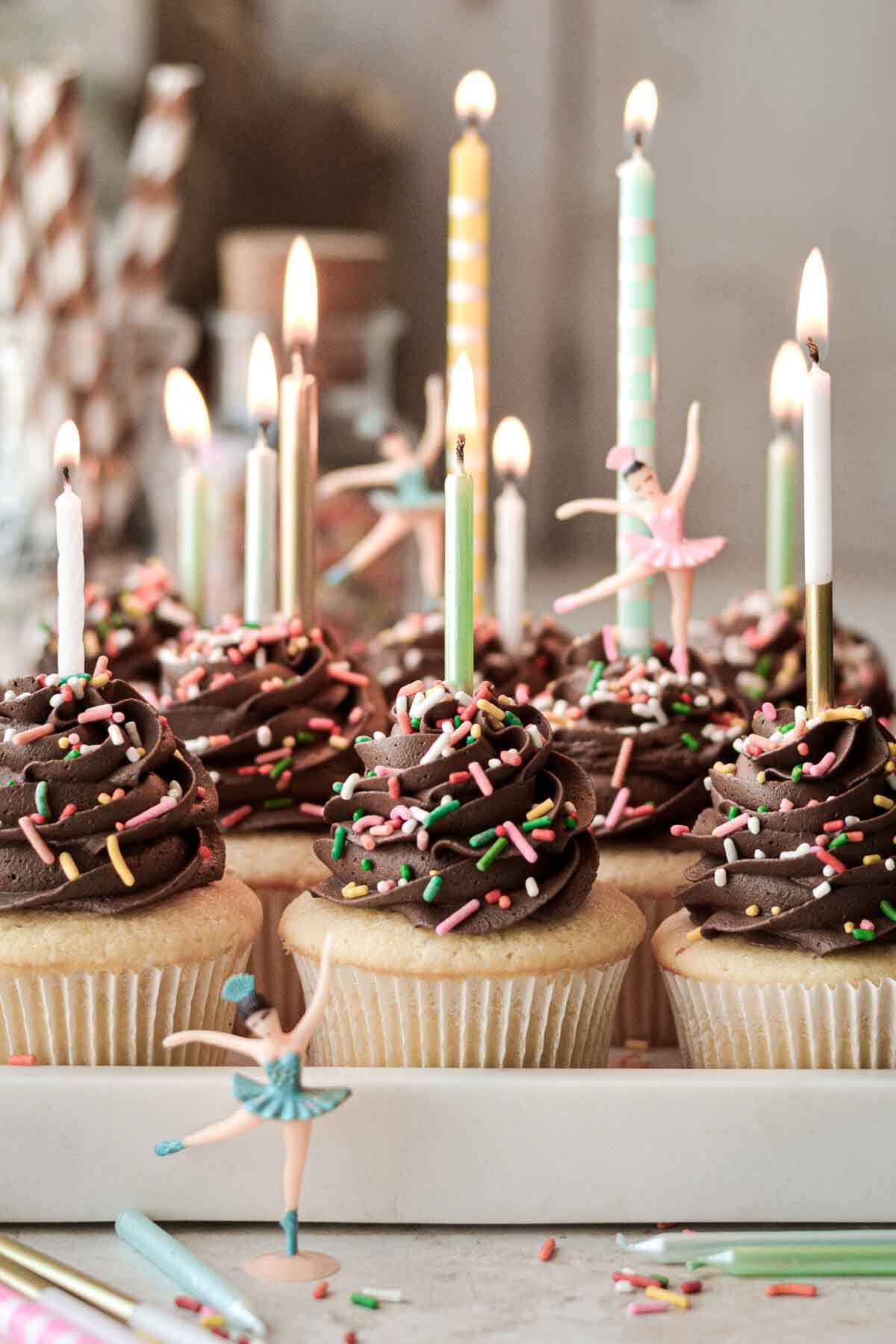 Vanilla birthday cupcakes with chocolate buttercream, sprinkles and candles.