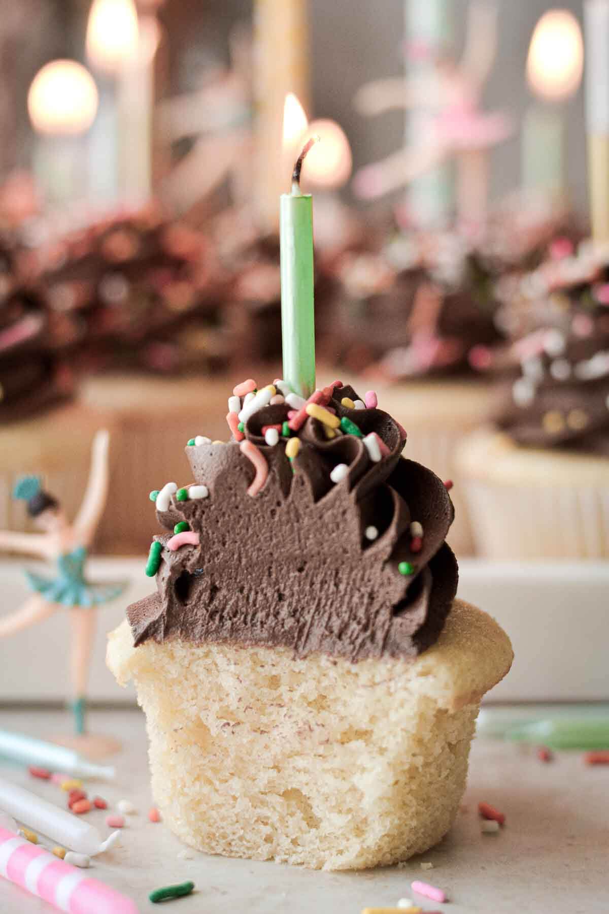 Vanilla chocolate cupcake with a bite taken.