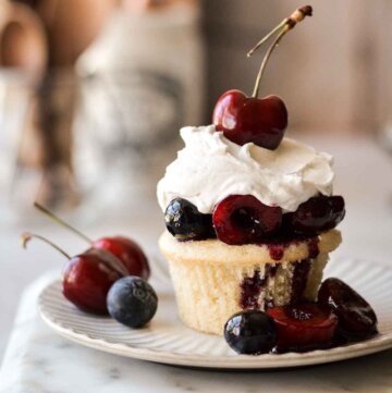 Cherry blueberry shortcake - a vanilla cupcake with berry compote and whipped cream.
