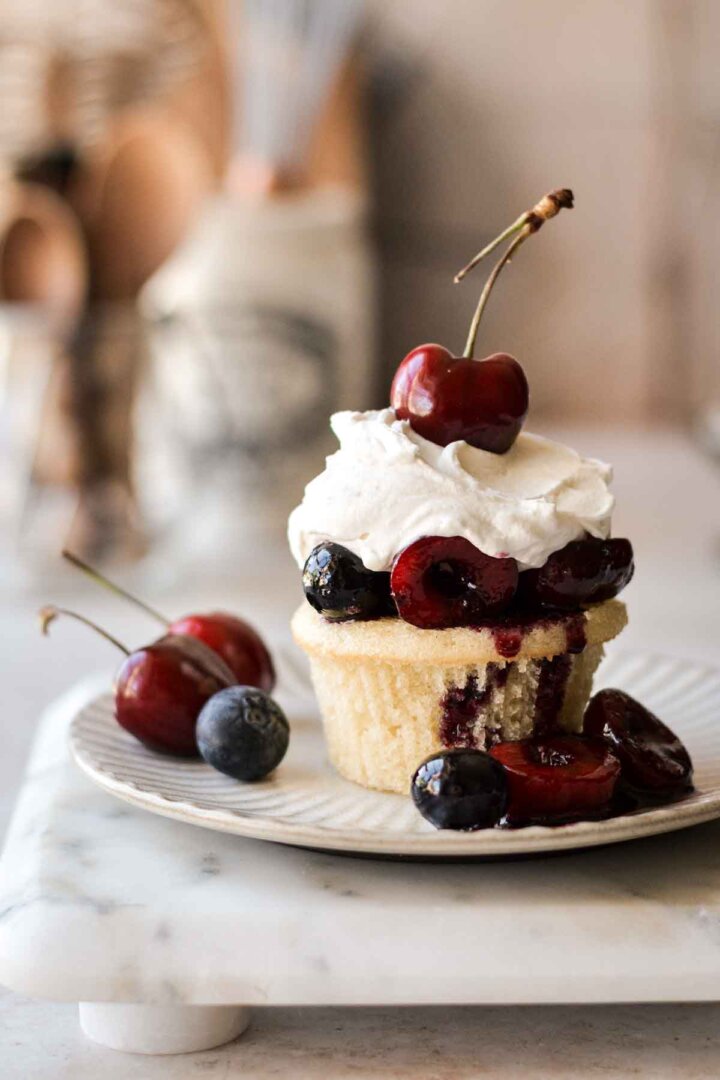 Cherry blueberry shortcake - a vanilla cupcake with berry compote and whipped cream.