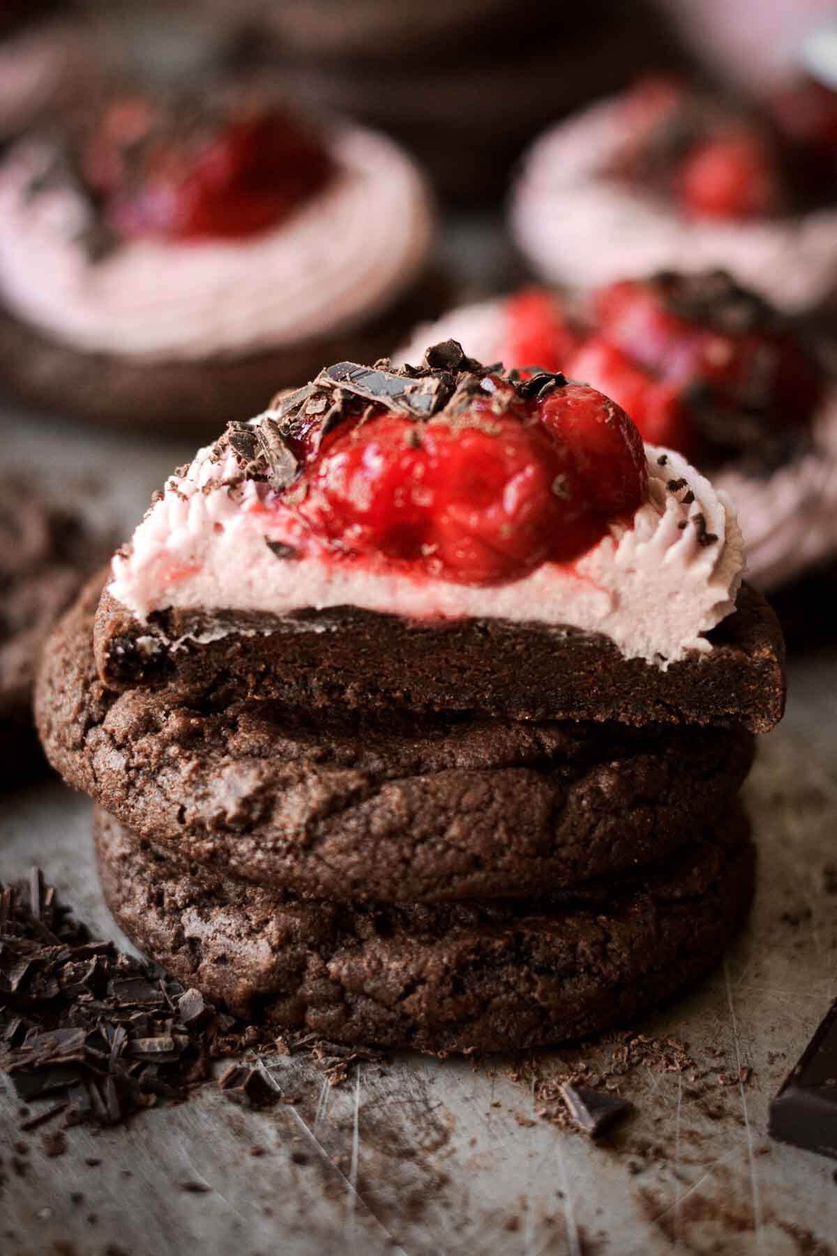 Stack of chocolate cherry cookies, one cut in half.