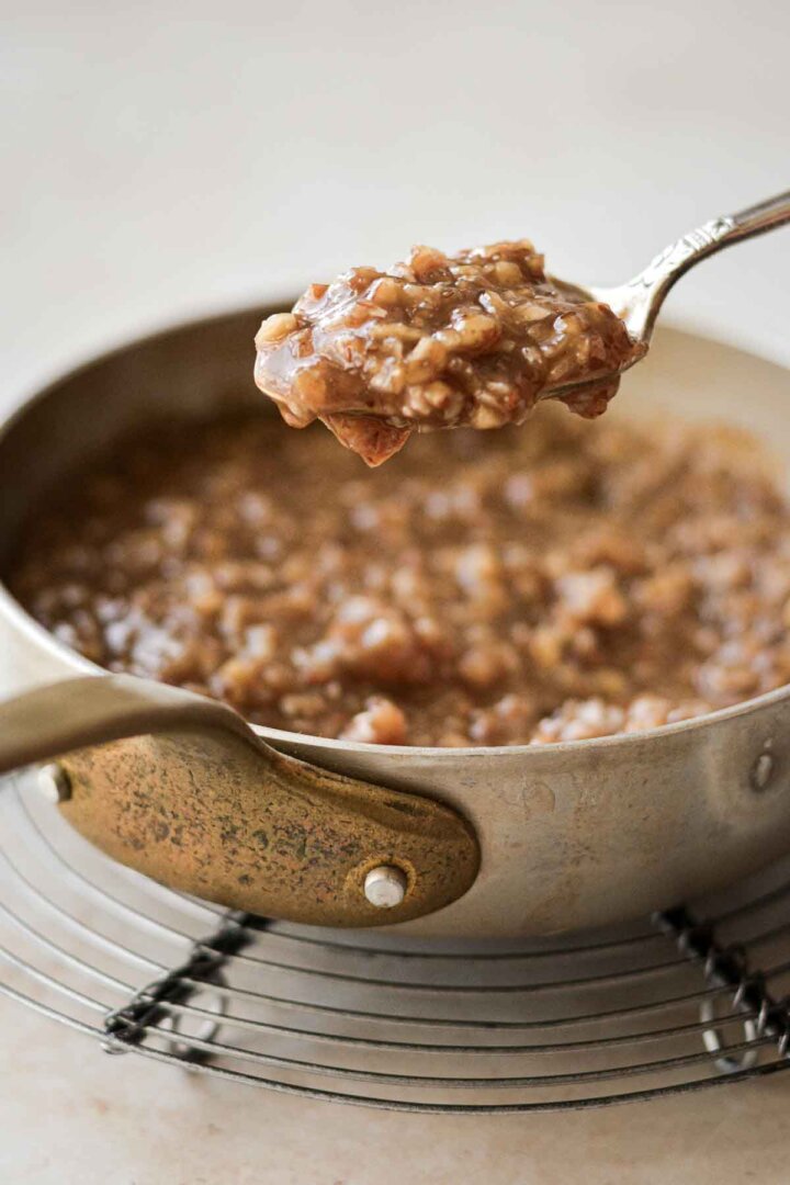Coconut pecan caramel frosting in a saucepan.