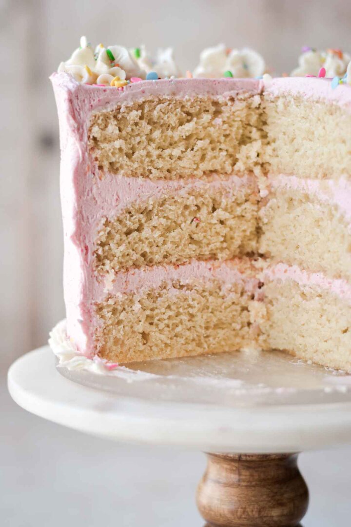 Gluten free vanilla birthday cake, cut to show the layers inside.