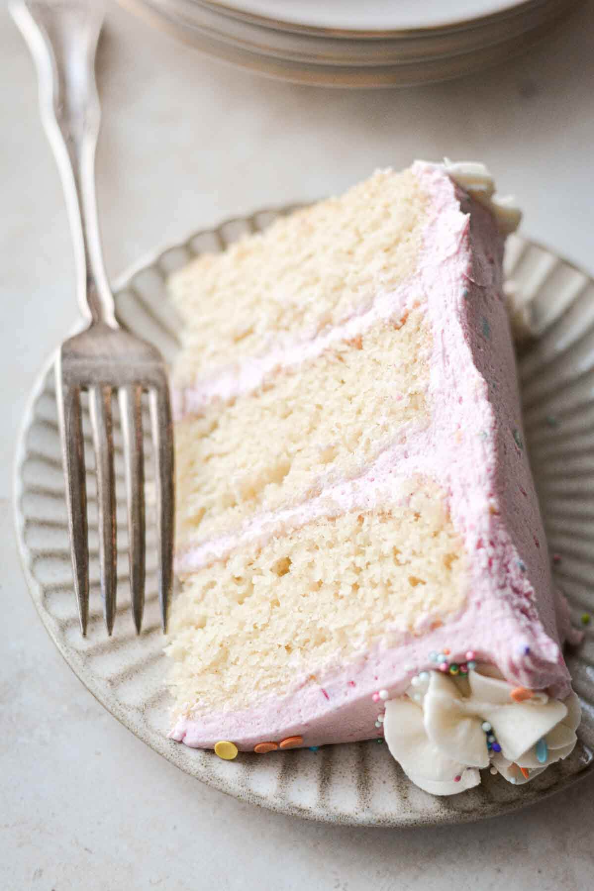 Slice of gluten free vanilla birthday cake.