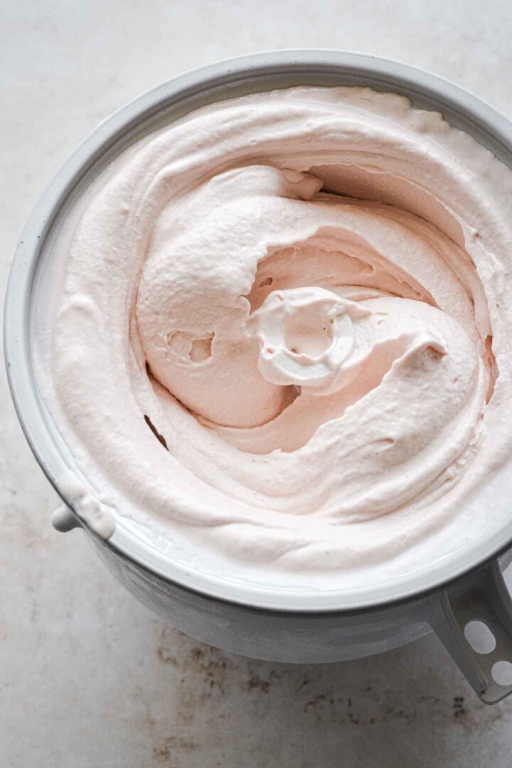Rhubarb ice cream in an ice cream maker.