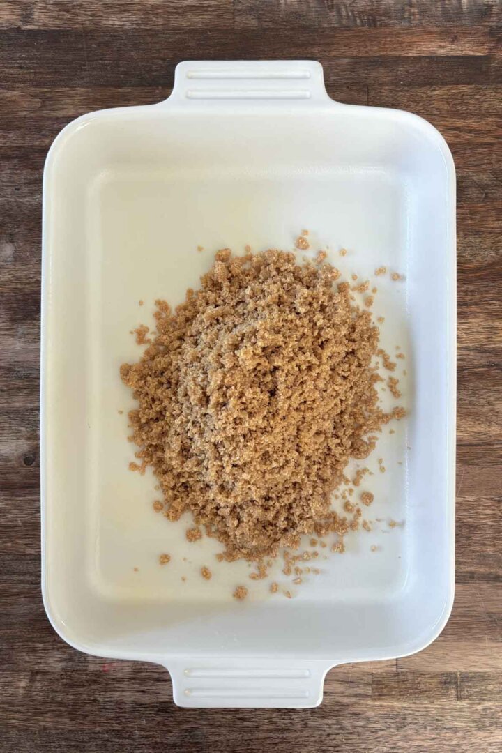 Graham cracker crumbs in a baking dish.