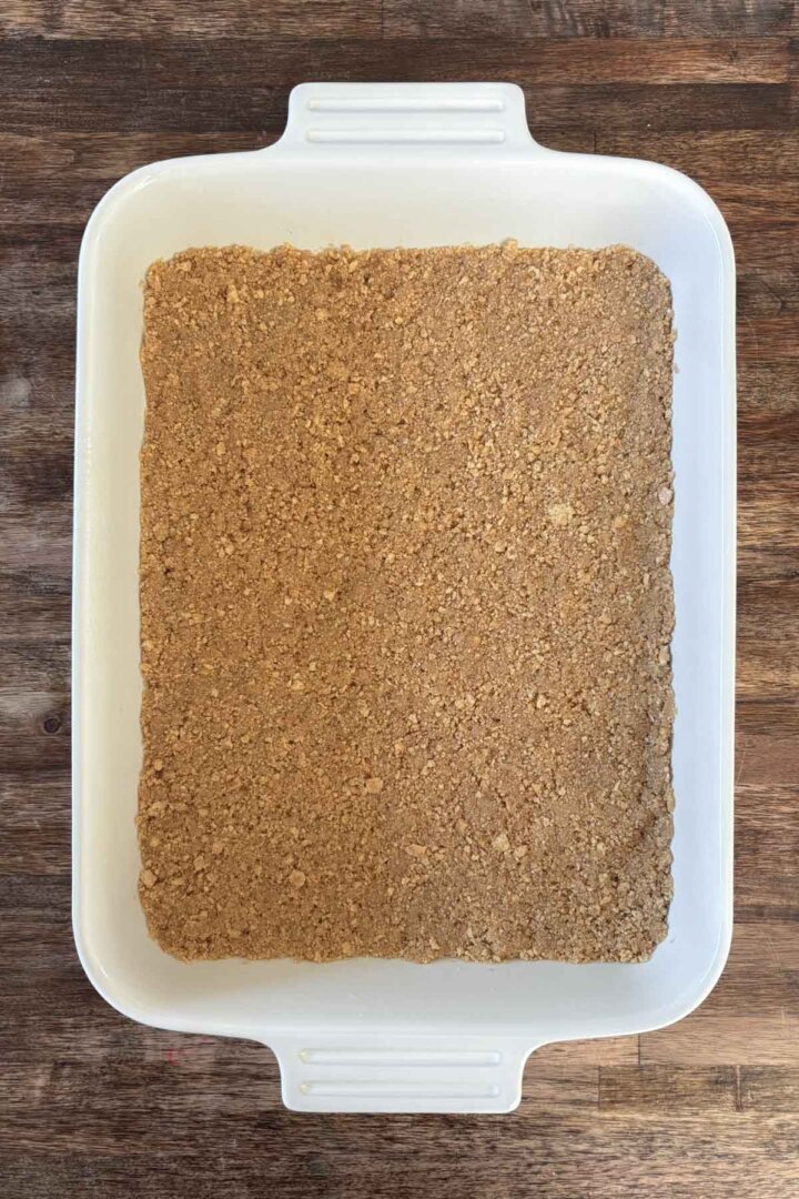 Graham cracker crust pressed into a baking dish.