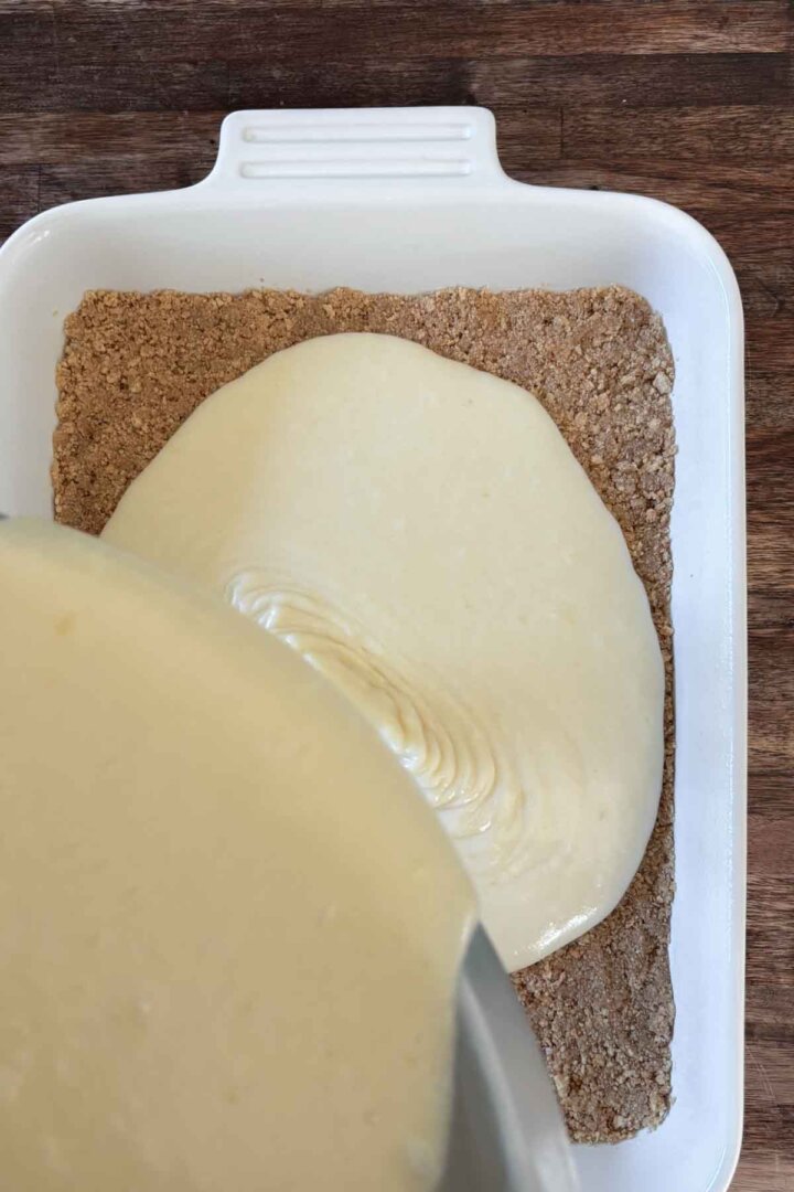 Vanilla cake batter poured over graham cracker crust.