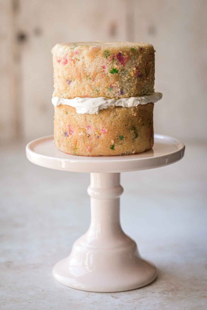 Two layers of confetti cake, filled with buttercream.