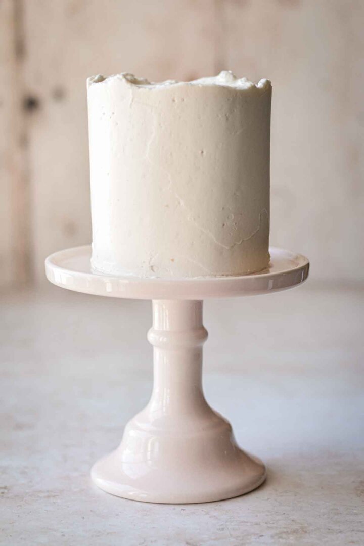 Mini cake with a smooth coat of vanilla buttercream.