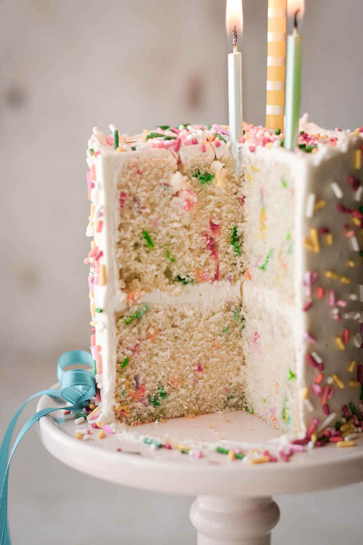 Mini sprinkle cake, with a slice cut to show the layers.