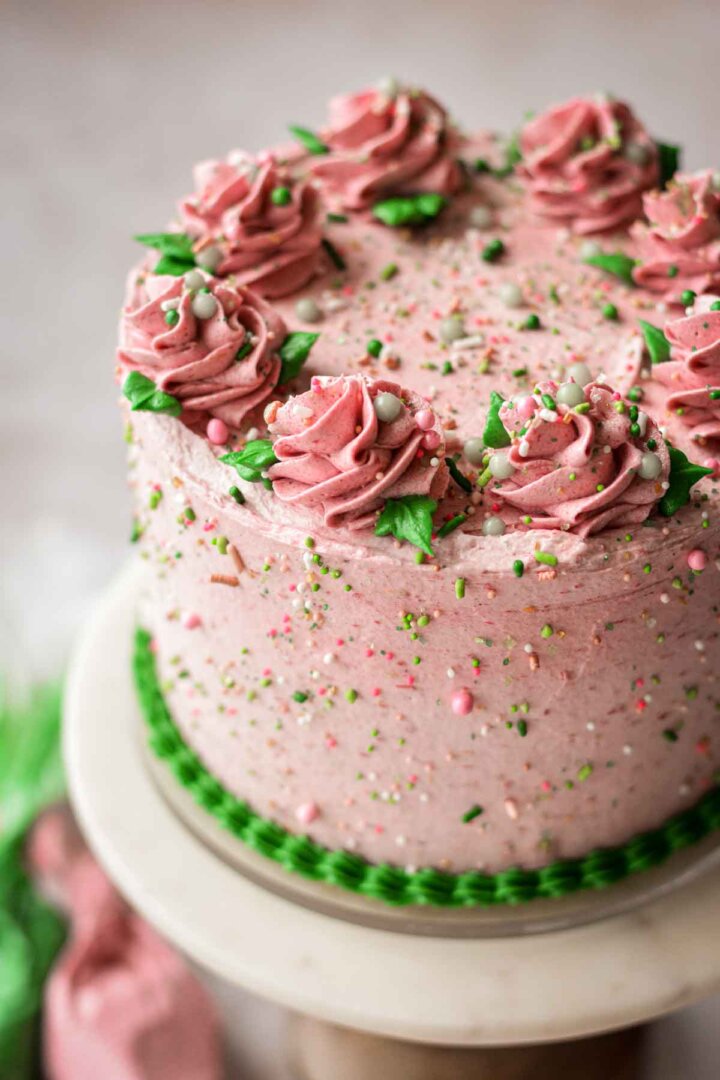 Strawberry cake, with pink and green buttercream, and sprinkles.