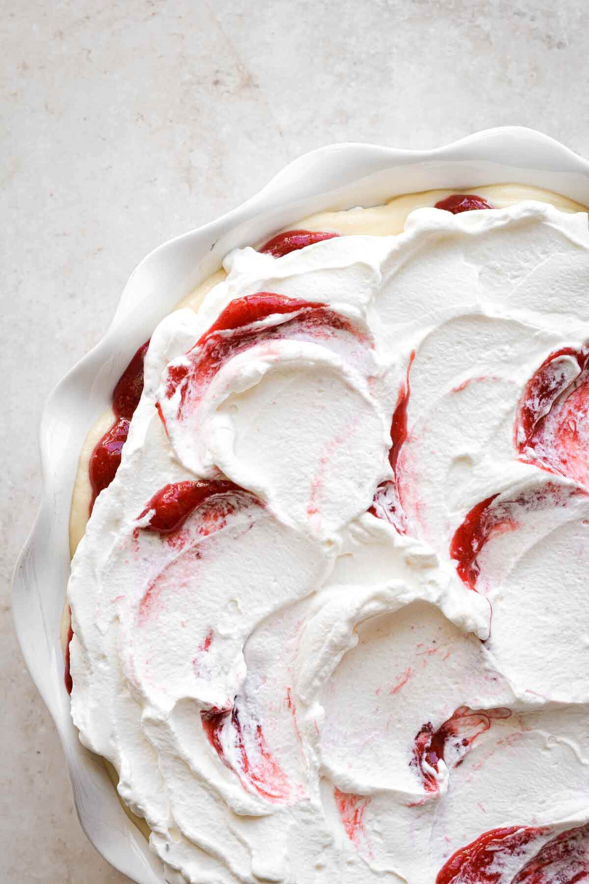 Strawberry pudding, layered in a white pie pan.