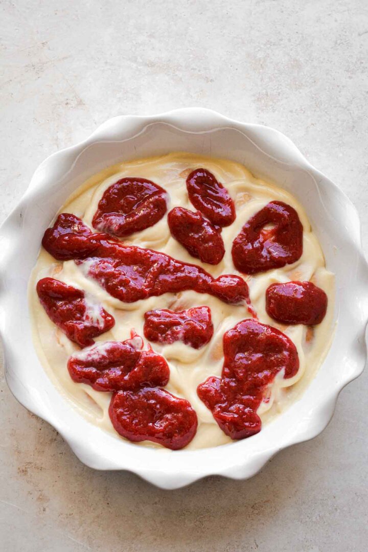 Step 3 for making strawberry pudding - dollops of strawberry compote over custard.