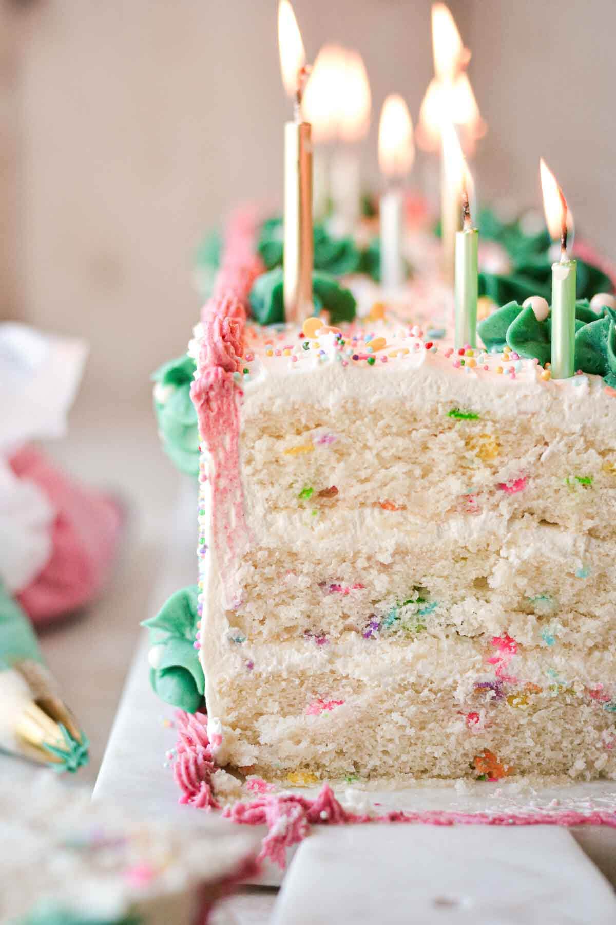 Birthday sprinkle cake cut to show the layers inside.