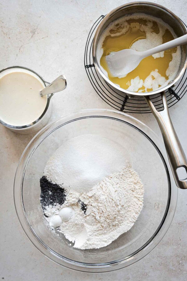 Step 1 for making almond poppy seed muffins - bowls of wet and dry ingredients.