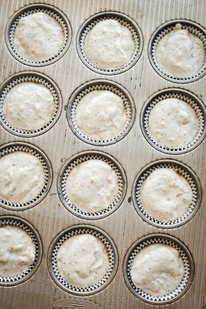 Step 4 for making almond poppy seed muffins - batter in muffin pan.