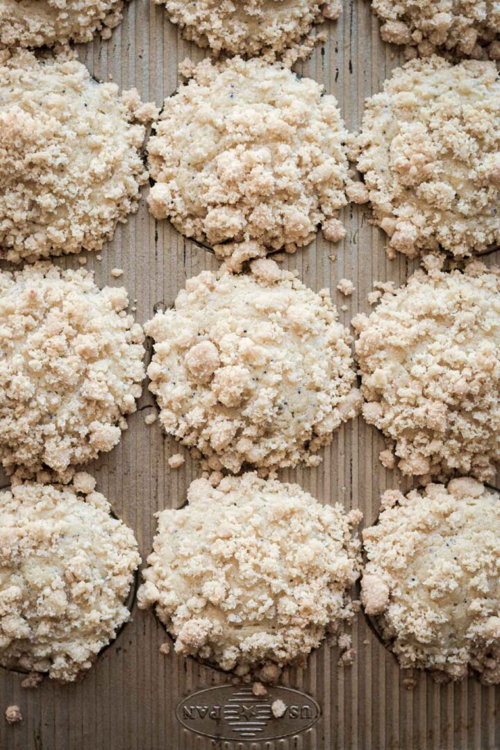 Step 6 for making almond poppy seed muffins - baked muffins in pan.