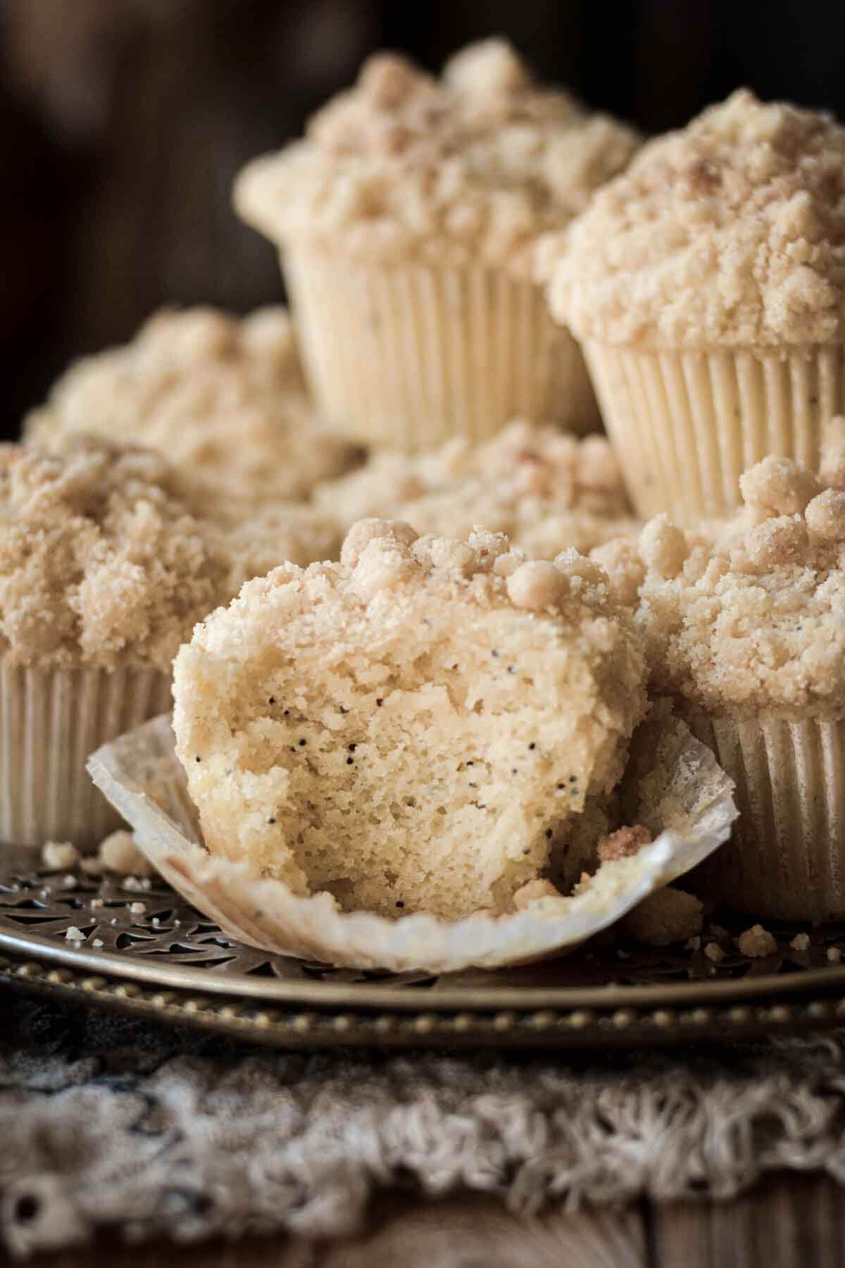 Almond poppy seed muffins, one with a bite taken.
