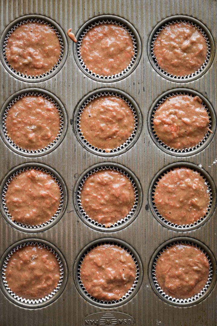 Step 5 for making carrot cake muffins - batter in muffin pan.