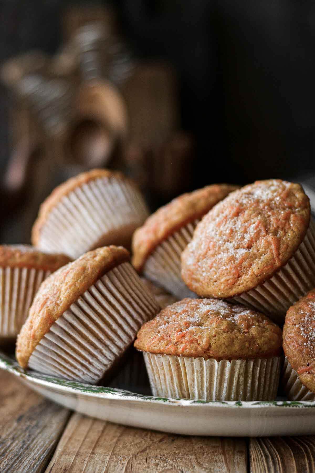 Carrot cake muffins piled on a plate.