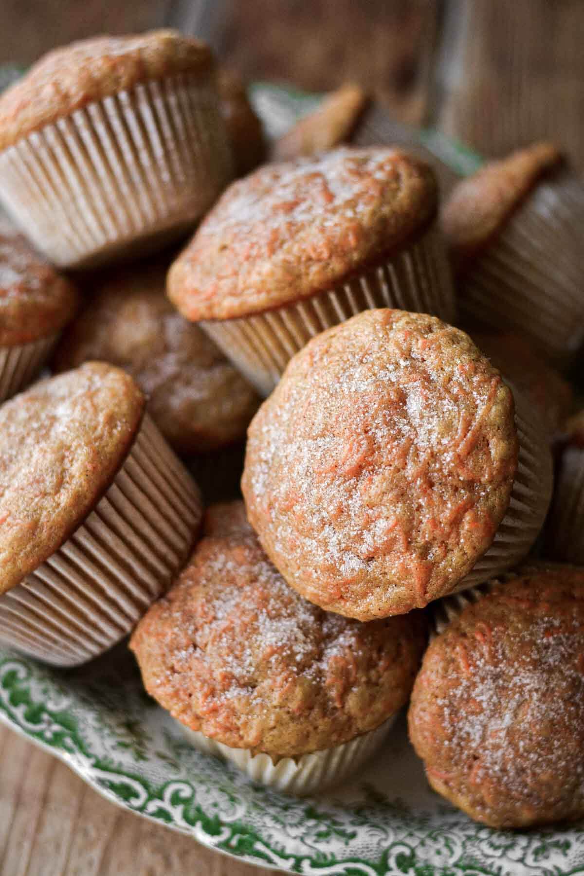 Carrot cake muffins piled on a plate.