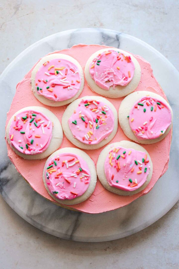 Step 3 for assembling a sugar cookie sprinkle cake - layer of cookies.