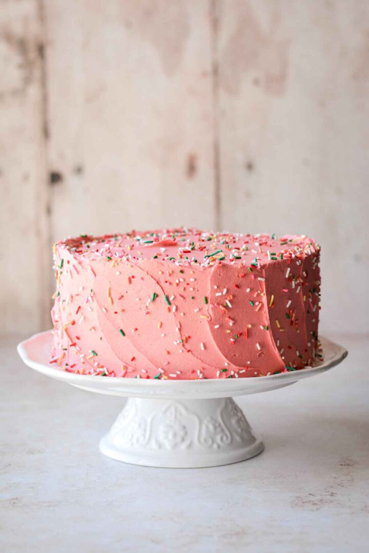 Step 8 for assembling a sugar cookie sprinkle cake - scattered with sprinkles.