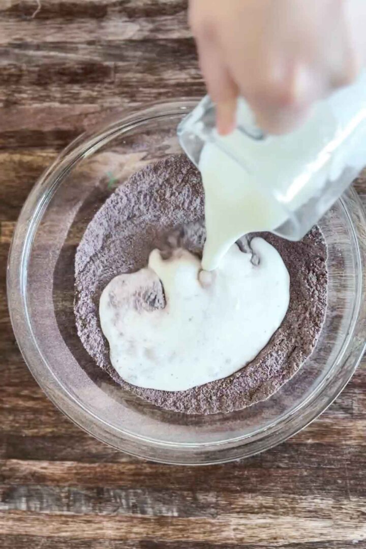 Step 2 for making gluten free chocolate cake batter - adding liquid ingredients.
