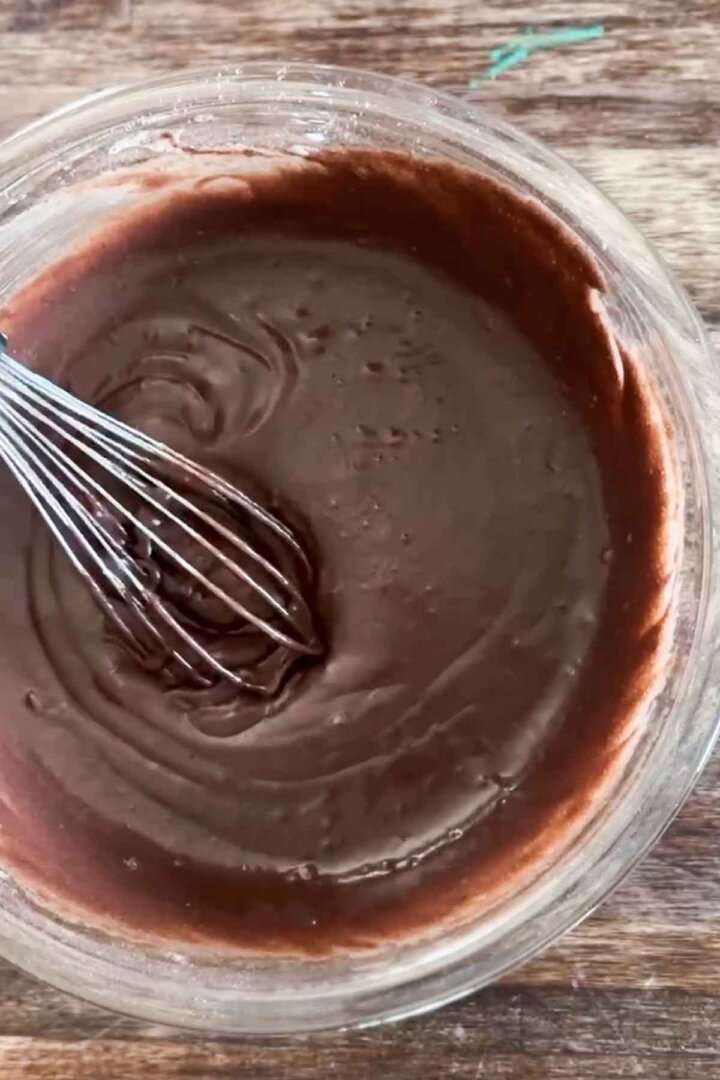 Step 4 for making gluten free chocolate cake batter - whisking the batter.