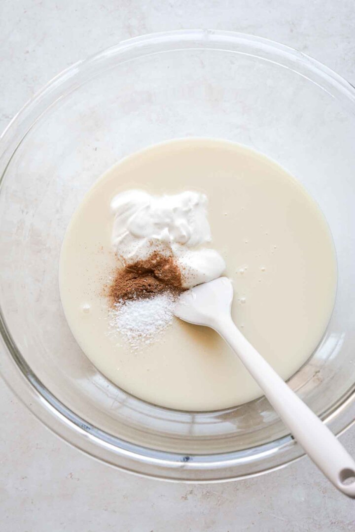 Step 1 for making oatmeal cookie ice cream - mixing sweetened condensed milk with spices and sour cream.