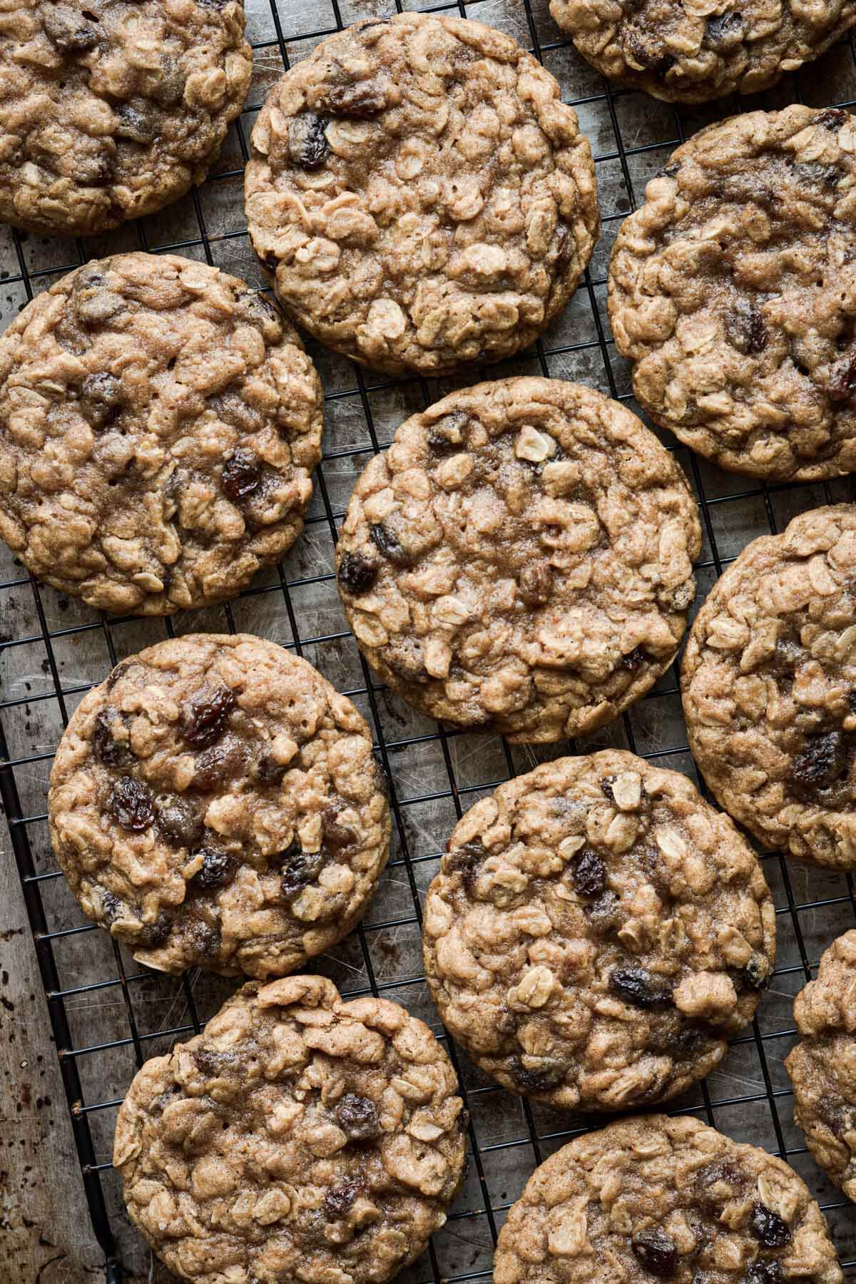 Oatmeal raisin cookies on a cooling rack.
