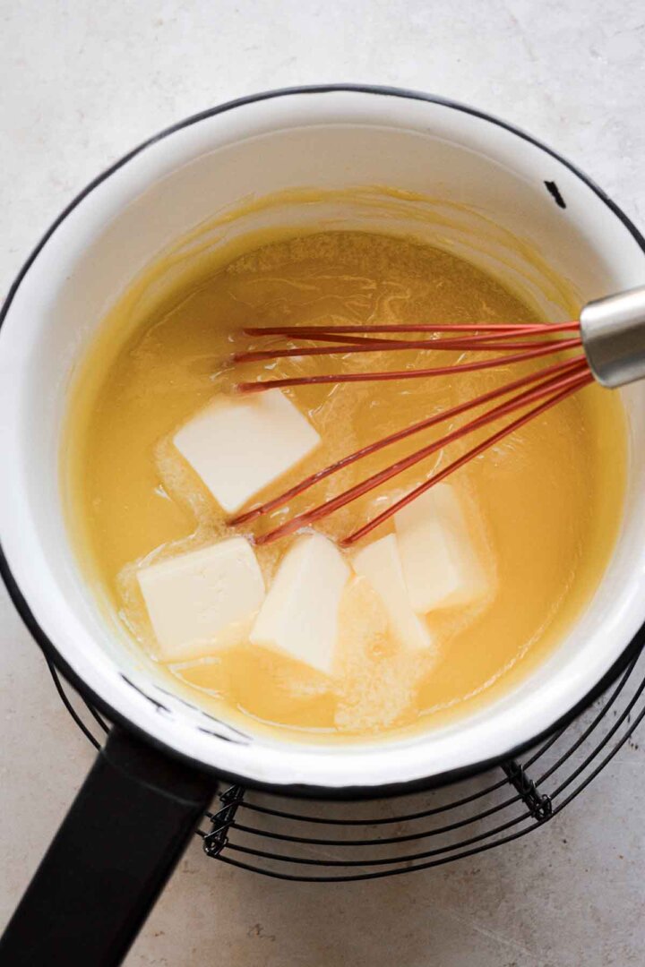 Whisking butter into pineapple curd.