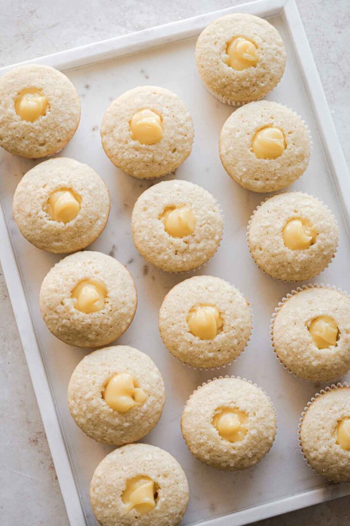 Coconut cupcakes filled with pineapple curd.