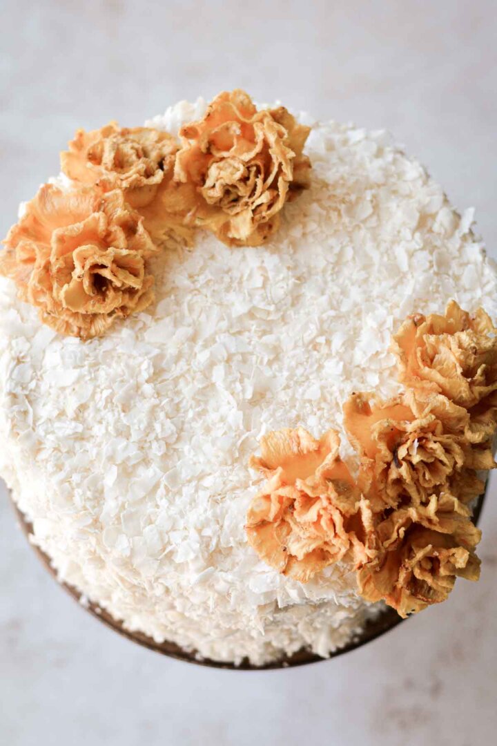 Dried edible pineapple flowers on a coconut cake.