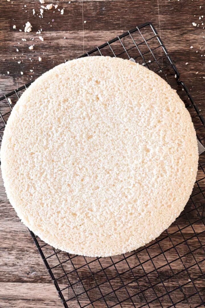 Vanilla cake on a cooling rack.
