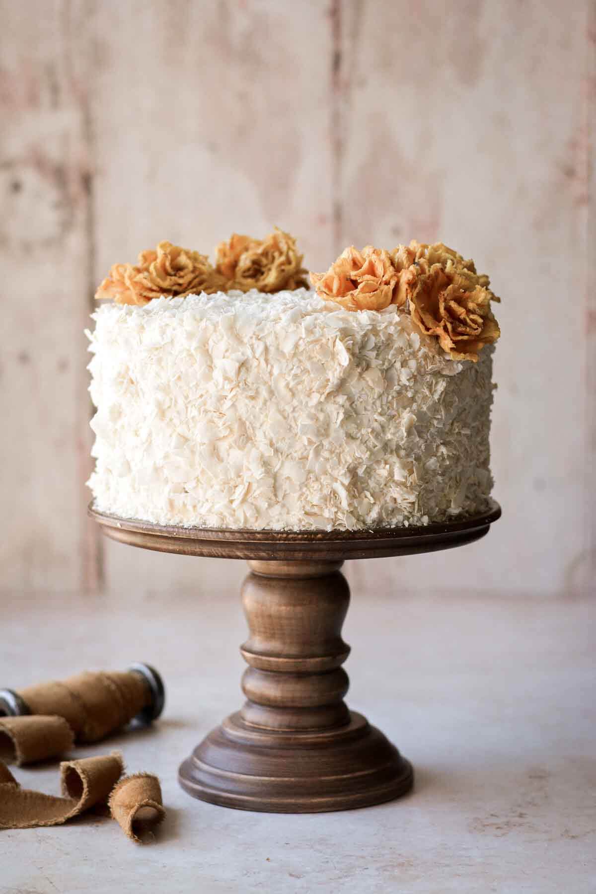 Pineapple coconut cake, decorated with dried edible pineapple flowers.