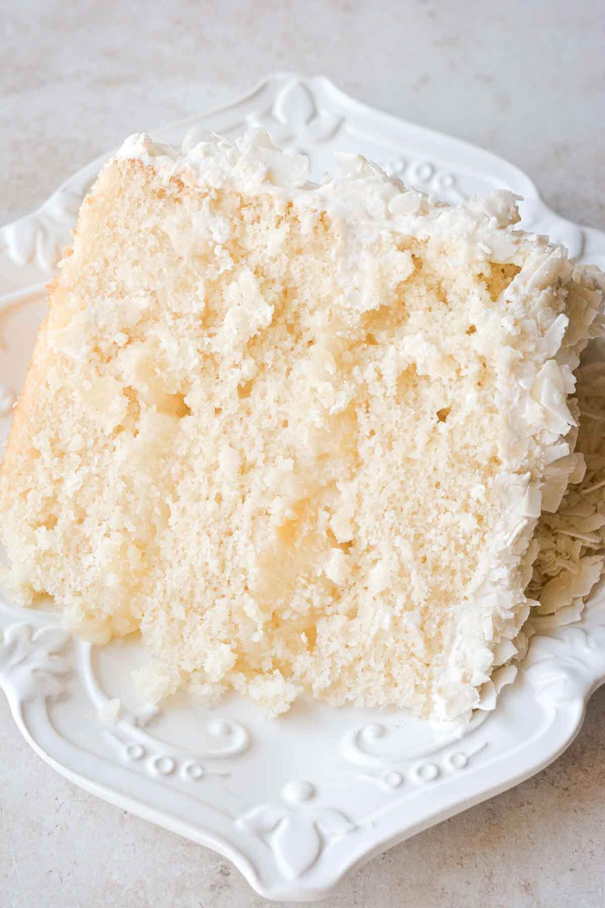 Slice of pineapple coconut cake on a plate.