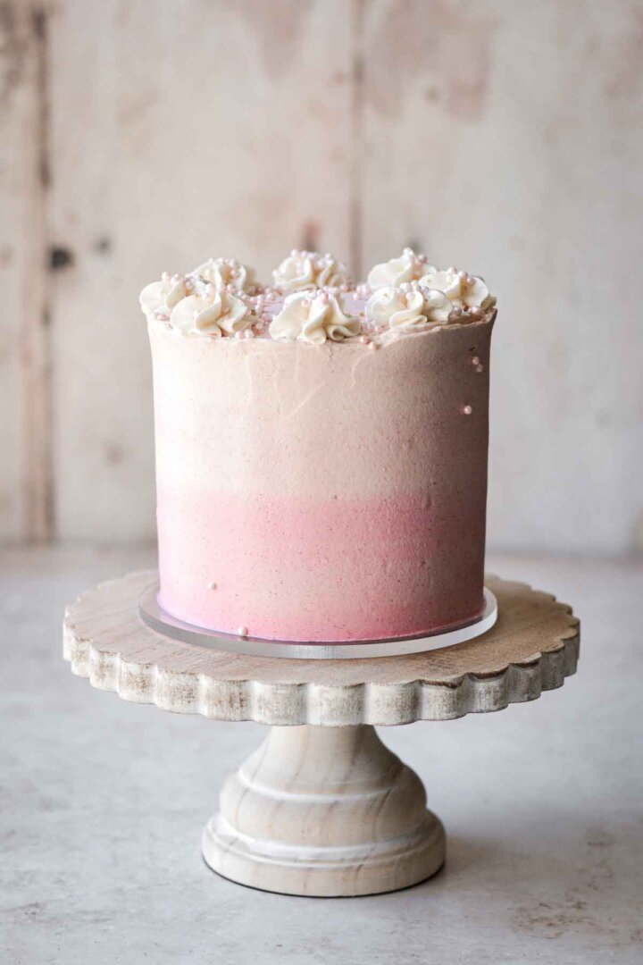 Pink ombre buttercream on a layer cake.