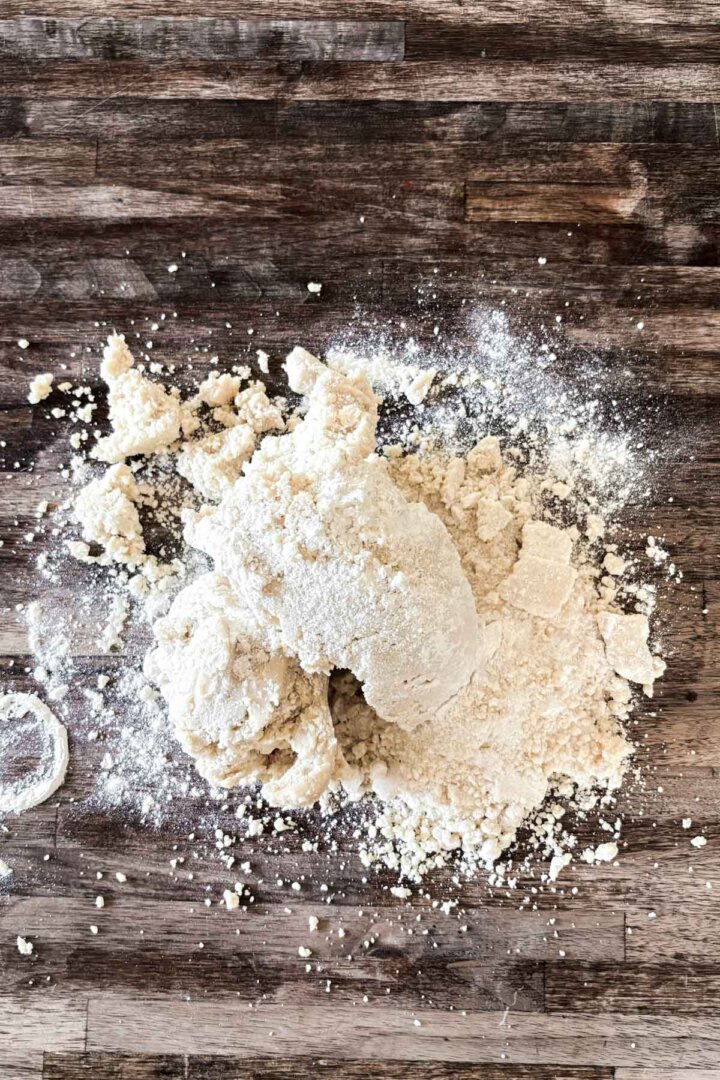 Step 3 for making shortbread cookies - gathering the dough crumbs.