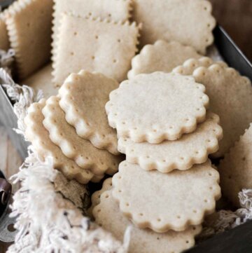 Vanilla shortbread cookies arranged in a tin container.