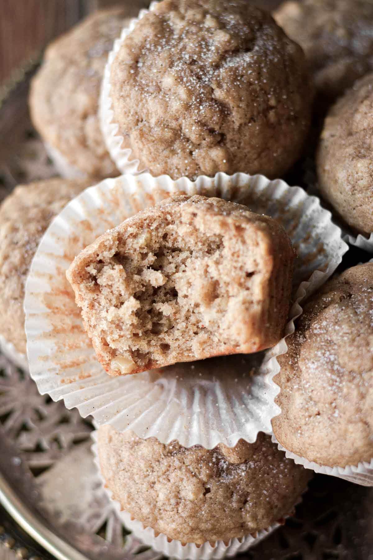 Banana muffins, one with a bite taken.