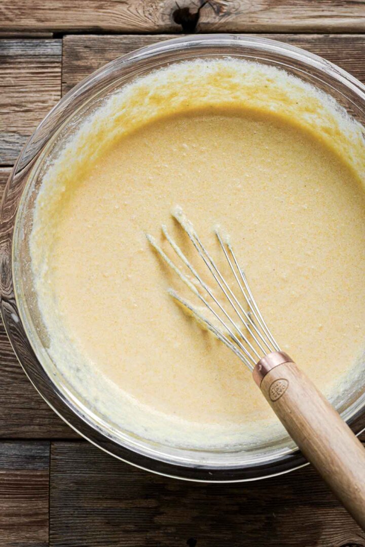 Step 2 for making corn bread - whisking batter.