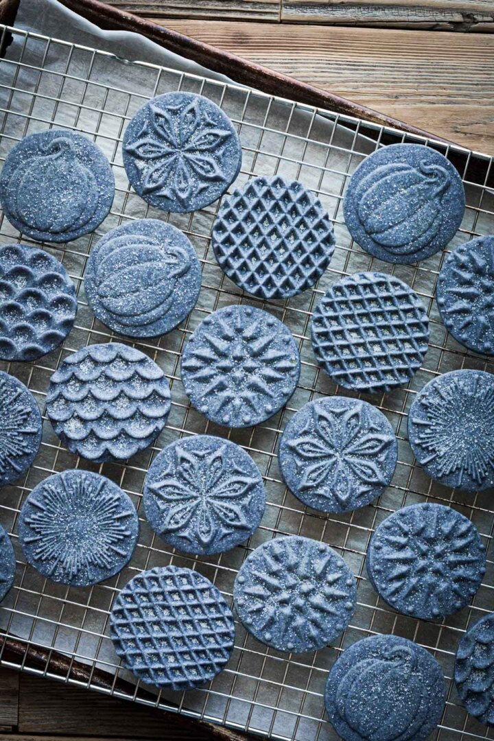 Blue shortbread cookies, pressed with cookie stamps, sprinkled with sugar.