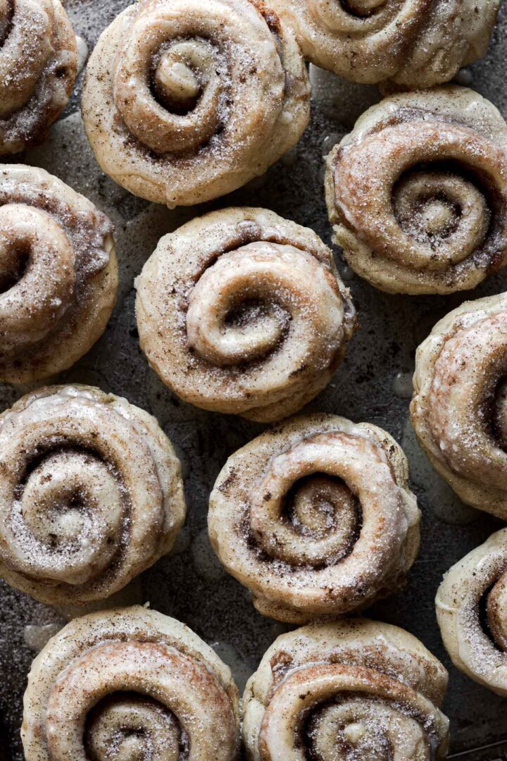 Cinnamon rolls drizzled with orange icing.