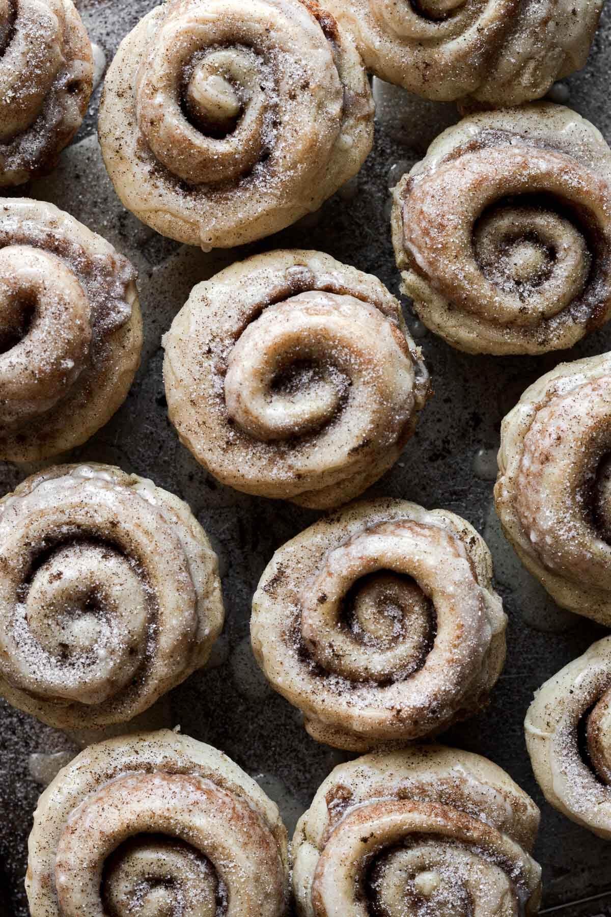 Cinnamon rolls drizzled with orange icing.
