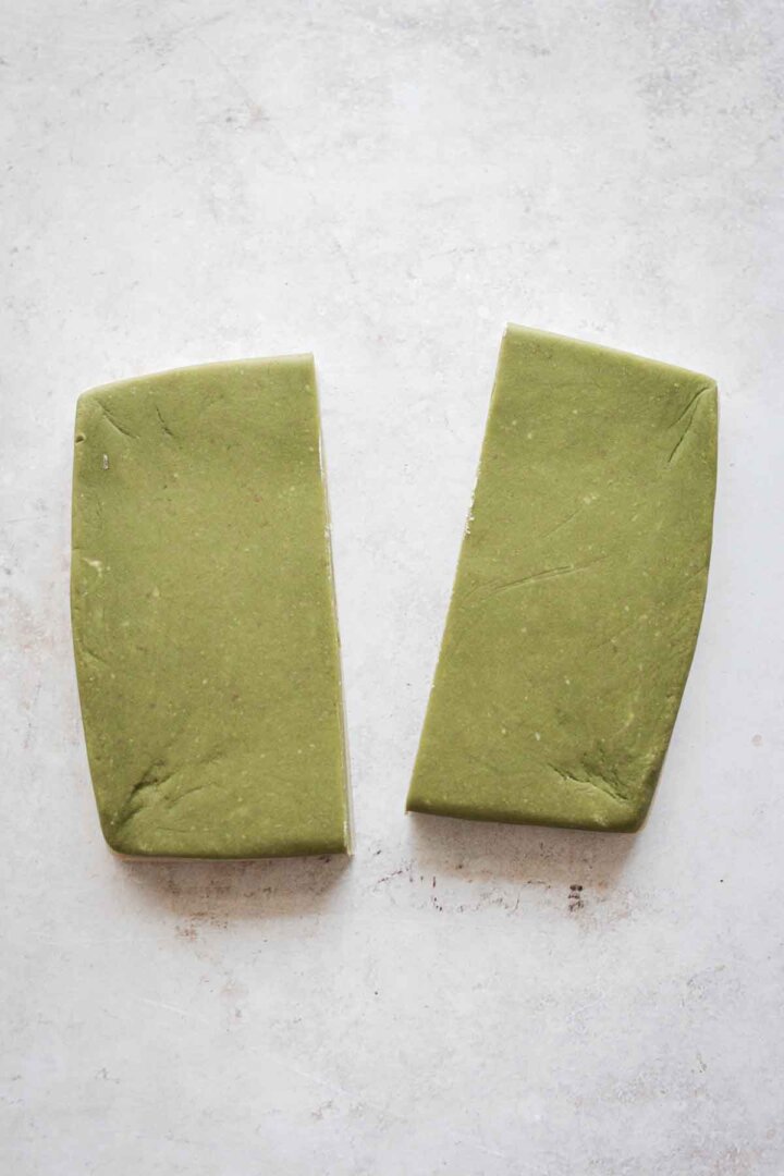 Step 2 for making green and white checkerboard cookies - cutting the dough in half.